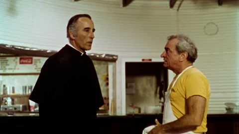 USA - 1977 - In this sci-fi horror, a priest speaks to a man in his restaurant. Stock Footage 327753300