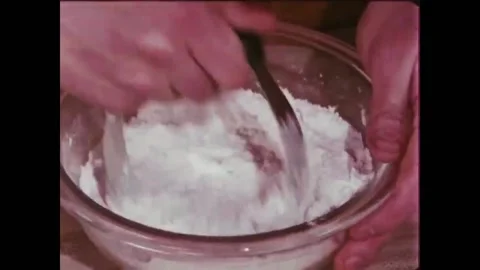 USA - 1981 - A baker demonstrates how to use a dough blender while making Stock Footage 261571645