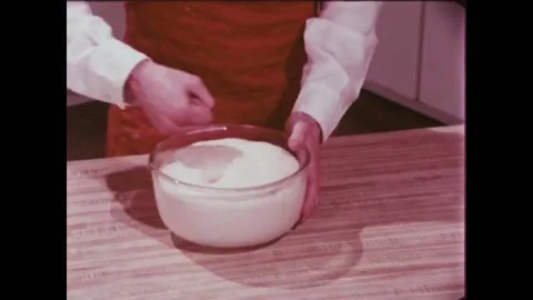 USA - 1981 - A baker punches down risen bread dough to release the gas bubbles. Stock Footage 261572476