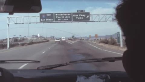 USA - 1985: passenger POV while driving on a 1980s us highway, old school cars Stock Footage 277936333