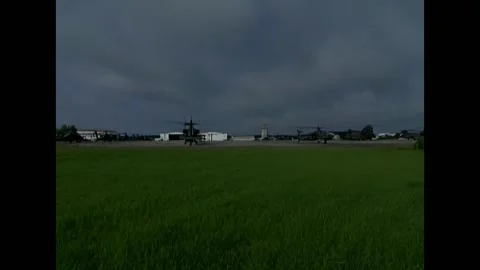 USA - 6.9.2025 - AH-64D Apache Longbow helicopters take off from a grassy Video stock 313139604