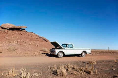 USA, Arizona, Broken pick-up truck on desert road Stock Photos