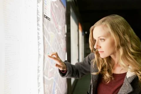 USA, California, Los Angeles, Woman at subway station checking map Stock Photos
