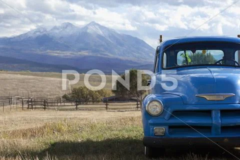 USA, Colorado, Carbondale, Blue vintage car, mount Sopris in background Stock Photos