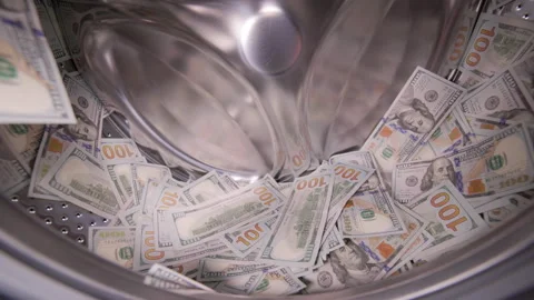USA Dollar banknotes are loading in a washing machine drum Stock Footage 329886212