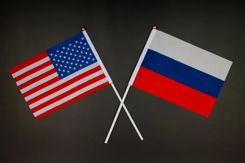 USA flag and Russia flag crossed with each other on the black background. USA Stock Photos