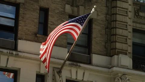 USA flag blowing outside of old New York City building close up RED 5K slowmo Stock Footage 107069049