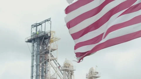 USA flag blowing in the wind with industrial factory behind in St. L Video stock 79851113
