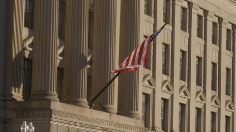 USA flag on facade of US Commerce building in Washington DC Stock Footage 128275347