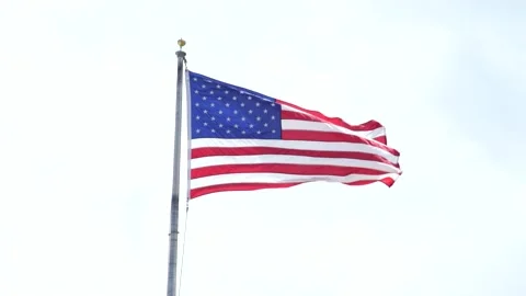 USA Flag floating in the wind with white background (overexposed) 스톡 동영상 135673936