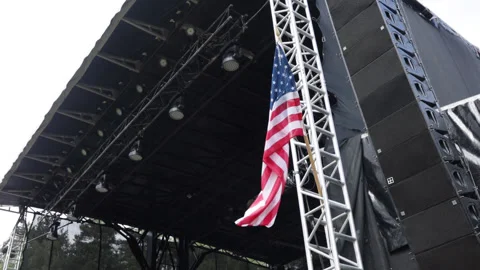 USA Flag flying on the stage construction. American flag flying outside. Stock Footage 205065643