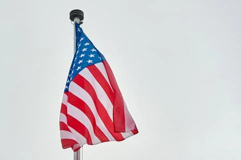 The USA flag is hanging on the flagpole Stock Illustration