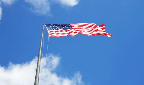USA flag low angle view with clouds and sky Stock Photos