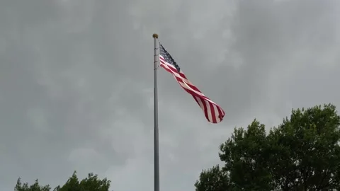 USA flag moving on the wind against grey sky Stock Footage 156737866
