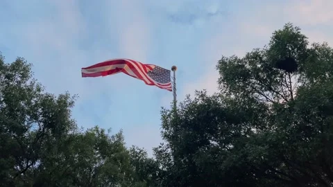 USA flag moving on the wind against blue sky Stock Footage 156744941