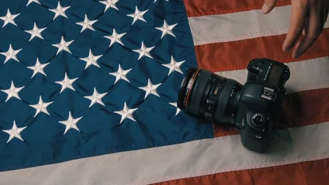 USA flag in slow motion. The camera lies on the flag. Hand picks up the camera Stock Footage 126496520