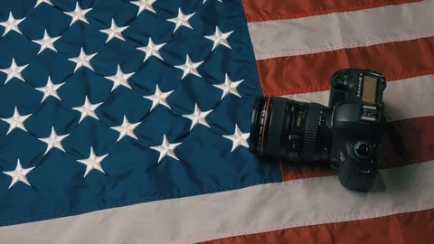 USA flag in slow motion. The camera lies on the flag. Hand picks up the camera Stock Footage 126496766