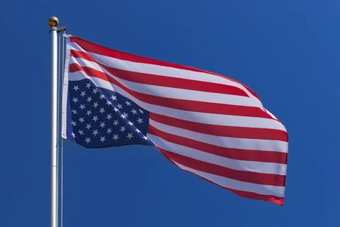 USA flag upside down on a flagpole Stock Photos
