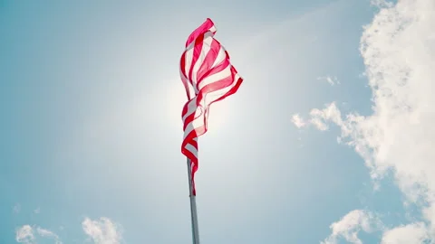 USA flag waiving on the flagpole with a background of the clear blue sky and Stock-Footage 308316101