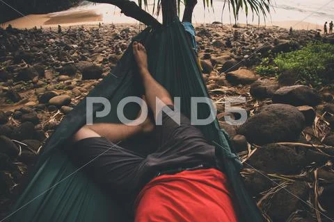 USA, Hawaii Islands, Kauai, Low section of man relaxing on hammock Stock Photos