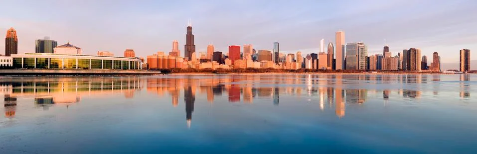 USA, Illinois, Chicago, City skyline over Lake Michigan at sunrise Stock Photos