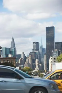 USA, New York City, Busy street with Manhattan skyline in background Stock Photos