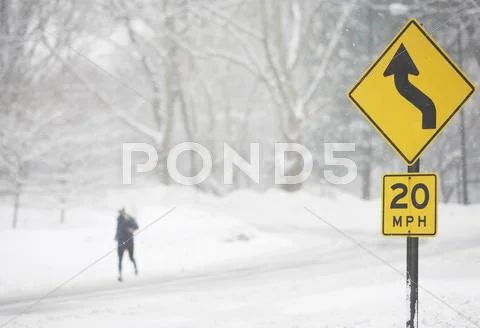 USA, New York City, speed limit and warning sign by snowy road Stock Photos