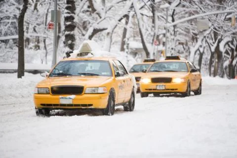 USA, New York City, yellow cabs on snowy street Stock Photos