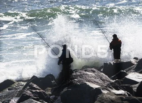 USA, New York, Long Island, Montaurk, Men fishing in sea Stock Photos