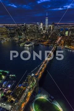USA, New York, New York City, Manhattan, Aerial view of illuminated skyline with Stock Photos