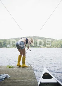 USA, New York, Putnam Valley, Roaring Brook Lake, Rear view of woman mooring Stock Photos