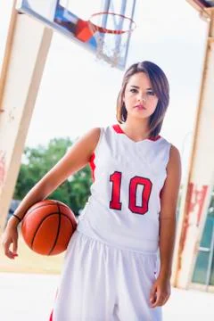 USA, Texas, American High School Girl in Sports Team Outfit with Basketball Stock Photos