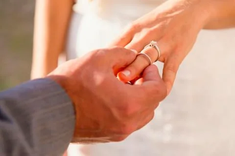 Usa, texas, groom inserting ring to bride, close up Stock Photos