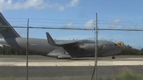 USAF C17 Global Master and Airliner Passing Behind in Airstrip Stock Footage 905625