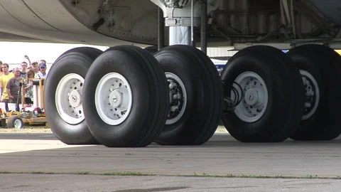 USAF Lockheed C-5 Galaxy - taxi past camera,- close-up on tires Stock Footage 90400542