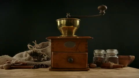 Usage of manual old fashioned coffee grinder. Female hand pouring roasted coffee Stock Footage 135397859