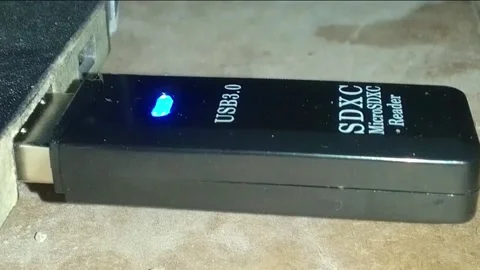 Usb 3.0 plugged on laptop with blue light, a sd micro card reader Stock Footage 238936092