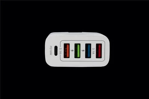 USB adapter for charging multiple mobile phones and modern devices on a bla.. Fotos Stock