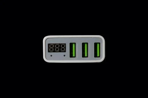 USB adapter for charging multiple mobile phones and modern devices on a bla.. Stock Photos