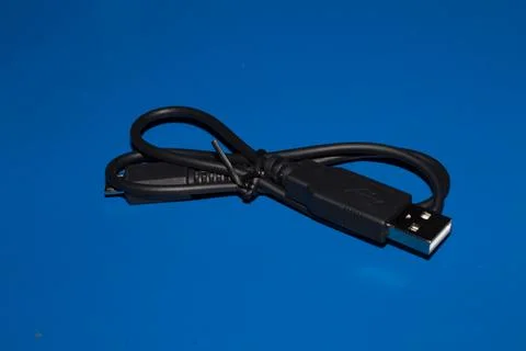 USB and micro USB cable blue background. Stock Photos