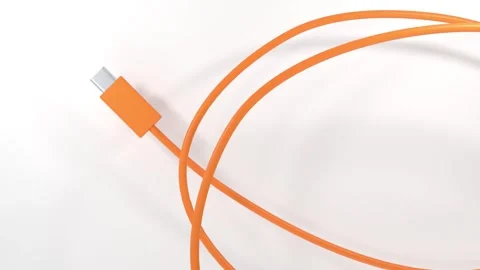 USB C Cable Animation on a White Background. Orange Color Cable Wire. 4K Stock Footage 313599117