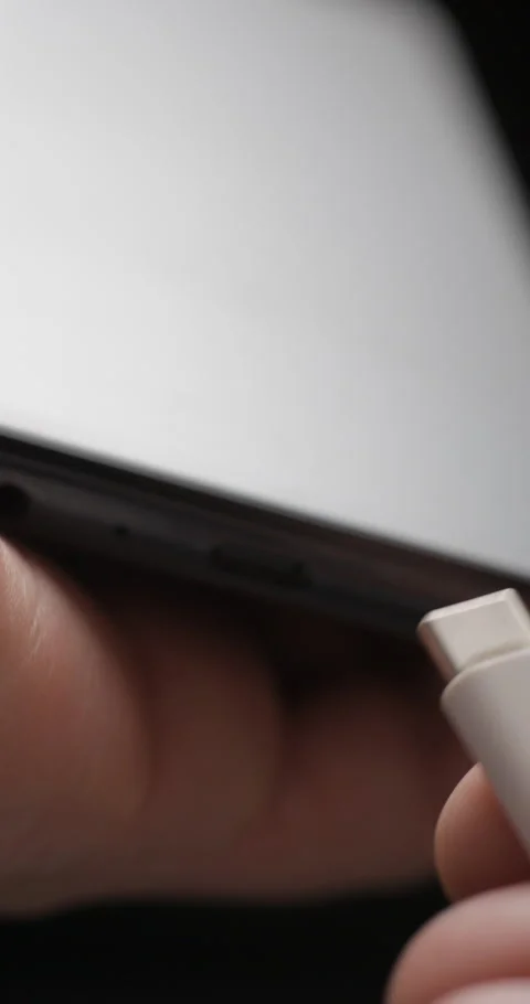 USB-C cable macro plugin to smartphone slow motion, vertical view Video stock 281040839