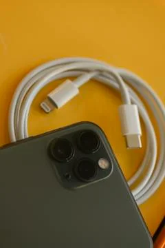 USB-C type to Lightning fast charging cable of with iPhone 11 Pro Max Stock Photos