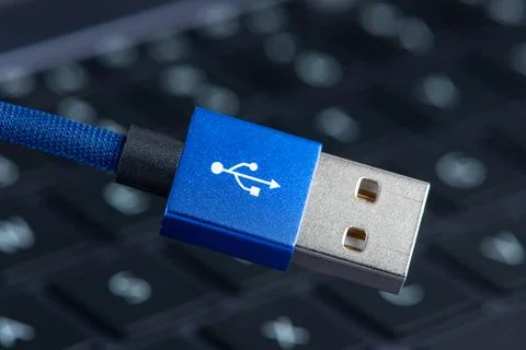 Usb cable close-up over laptop keyboard Stock Photos