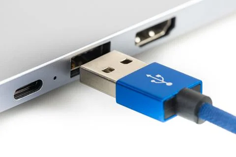 Usb cable connect to laptop close-up isolated on white Foto stock