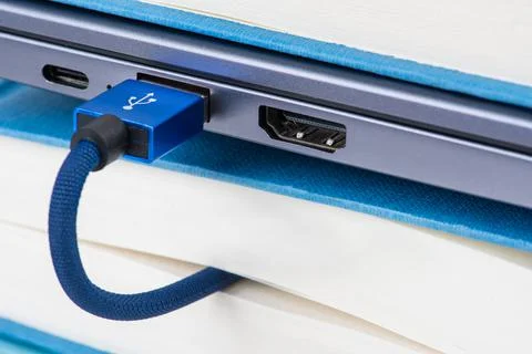 Usb cable connected to book Stock Photos