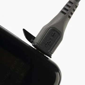 USB cable connected on a mobile phone 스톡 사진