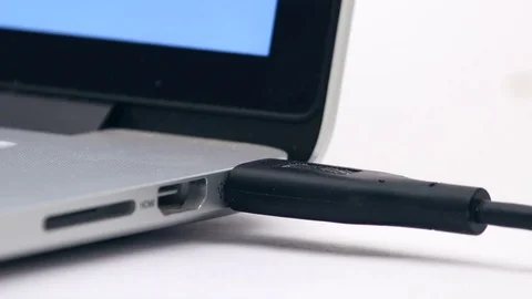 USB cable connecting to laptop computer closeup Stock Footage 73313758