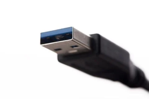 USB cable connector with blurred cable close up on white background Foto stock