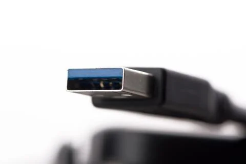 USB cable connector with blurred cable close up on white background Stock Photos